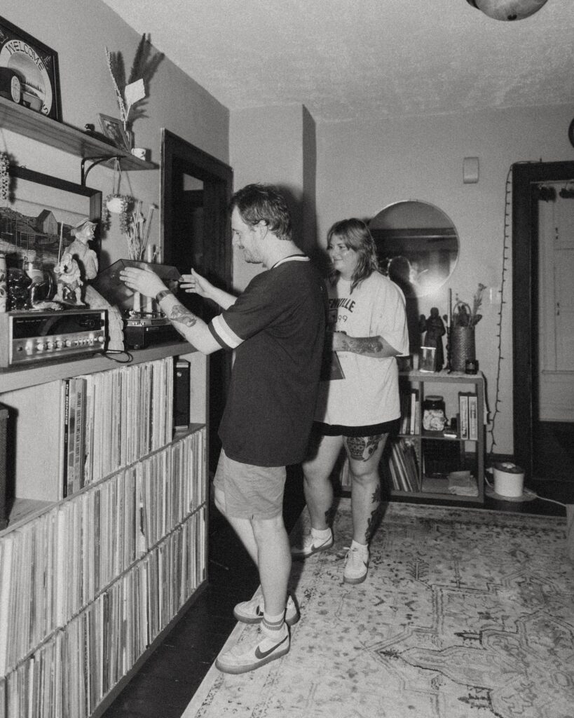 couples photography, a couple stands in their home and put a record on the record player