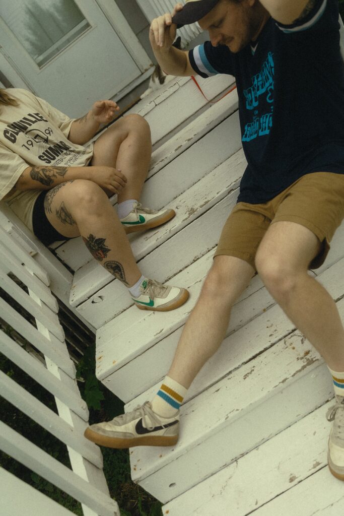 a couple sits on the stairs in front of their front door