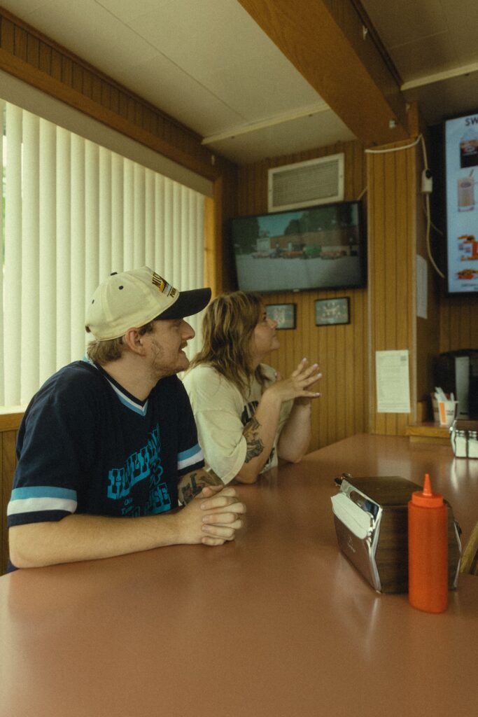 a couple sit together at the bar at a&w