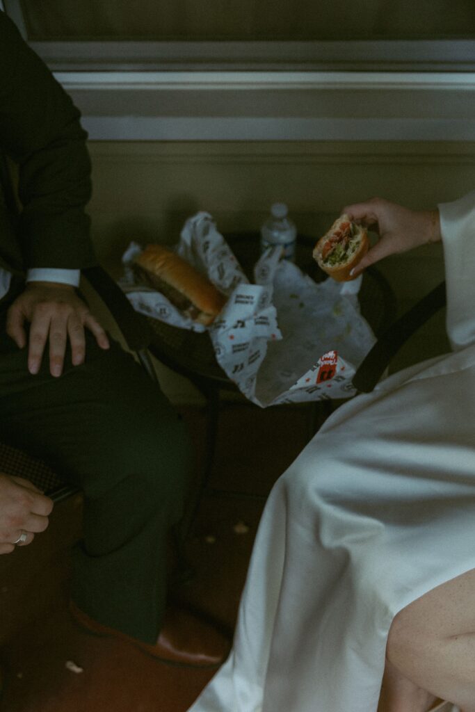 a couple eloping in michigan share two jimmy johns sandwiches