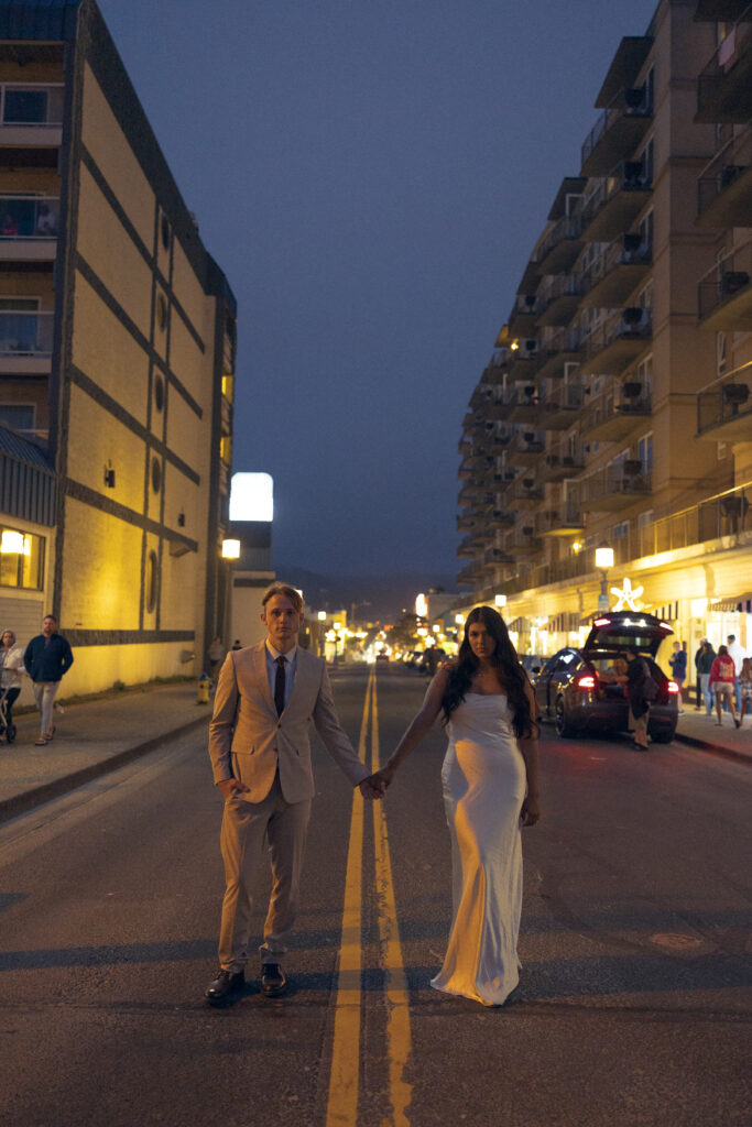 a couple stands in the middle of an oregon street while holding hands during their elopement