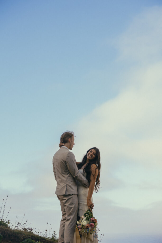 a couple stand in an embrace laughing during their oregon elopement