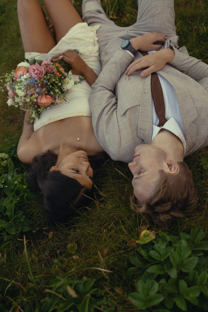 a couple lay on the ground during their oregon elopement