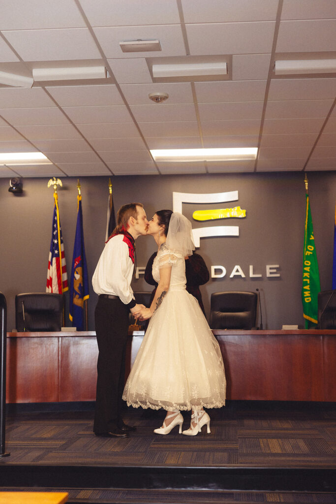 A bride and groom are pictured in their wedding attire eloping in Michigan at a courthosue