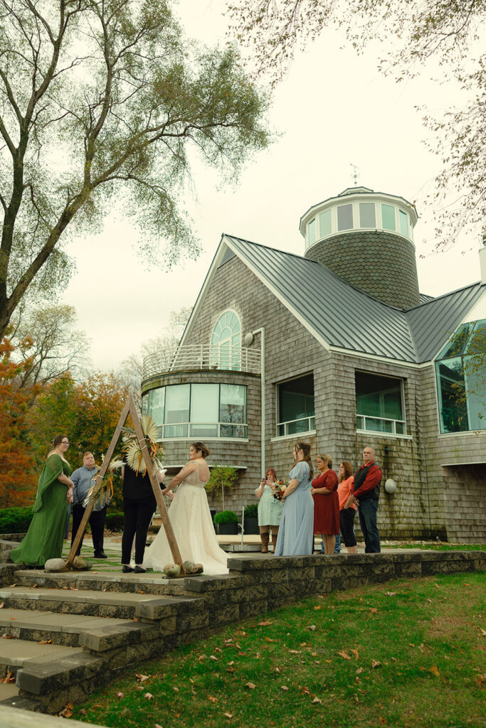 A Michigan couple is photographed standing beneath a triangular altar at one of the places to elope in michigan