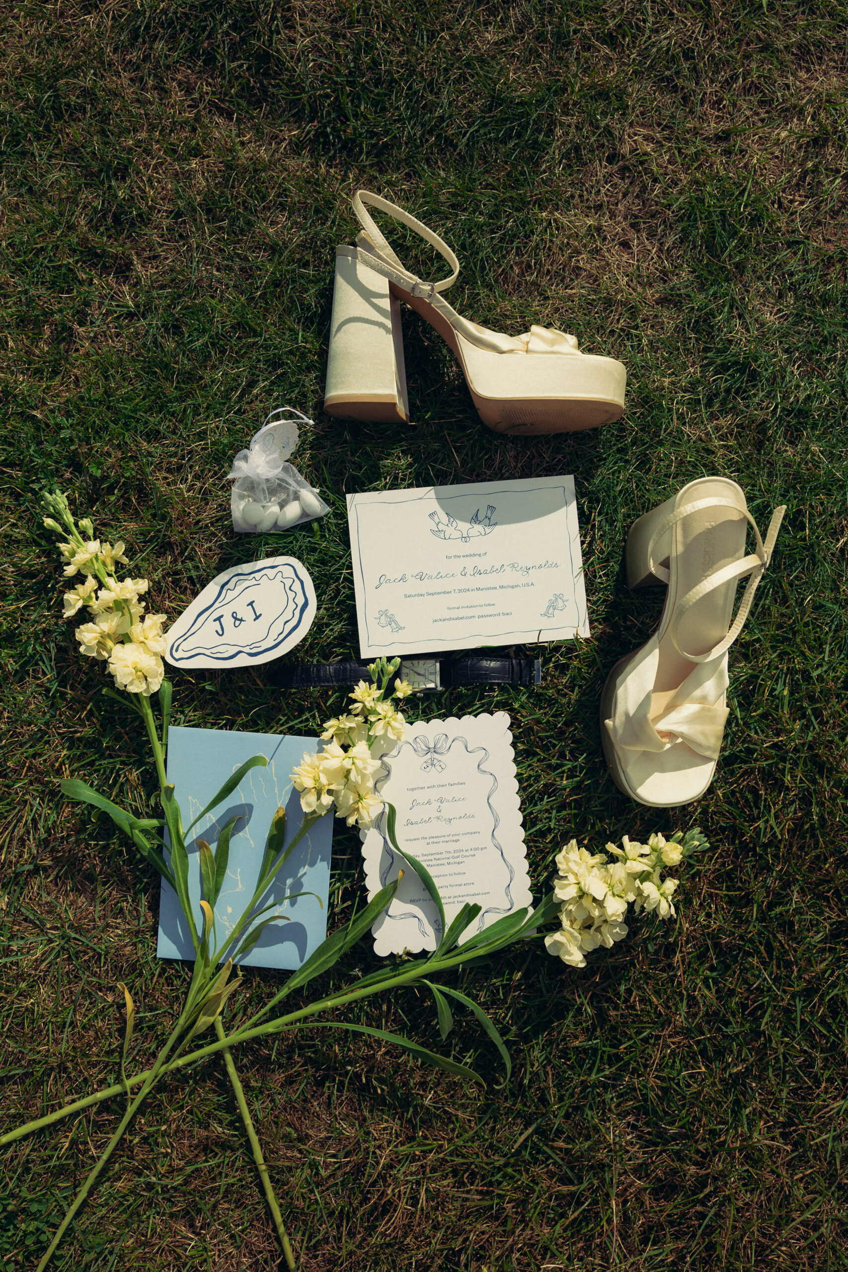 wedding day details sit in the grass of a northern michigan wedding