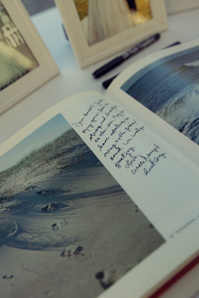 a handwritten message in the guest book at a reception with documentary style wedding photos