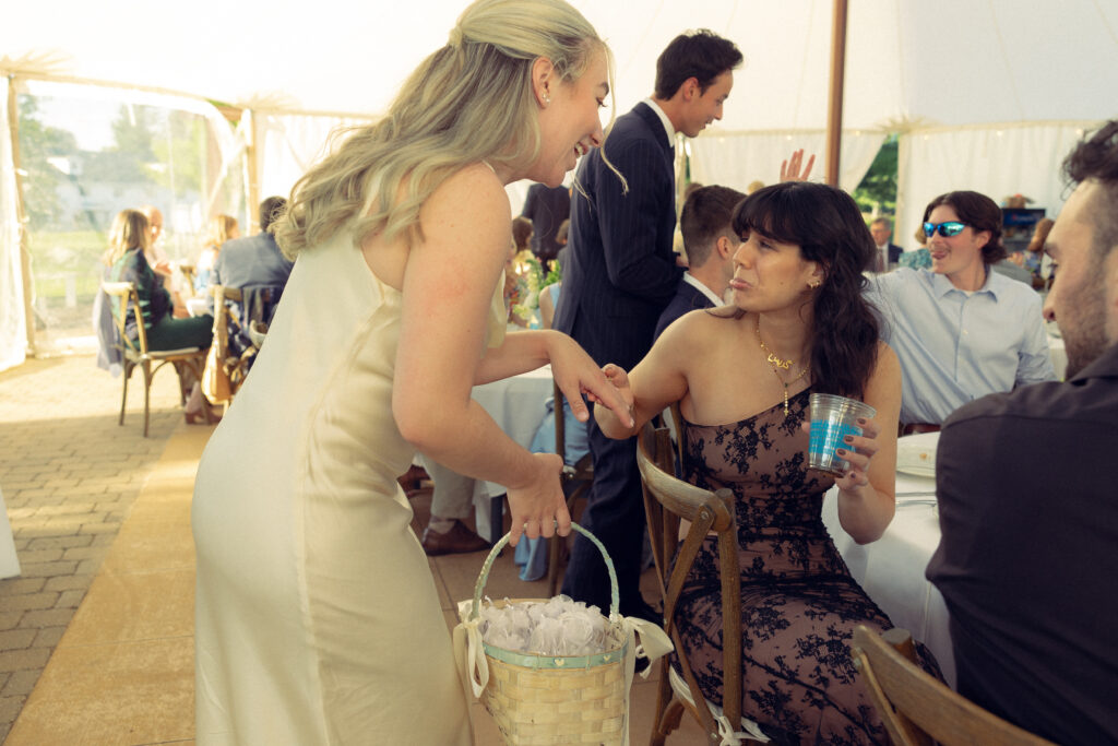 the bride talks with a guest in a deep, sweet conversation in documentary style wedding photos