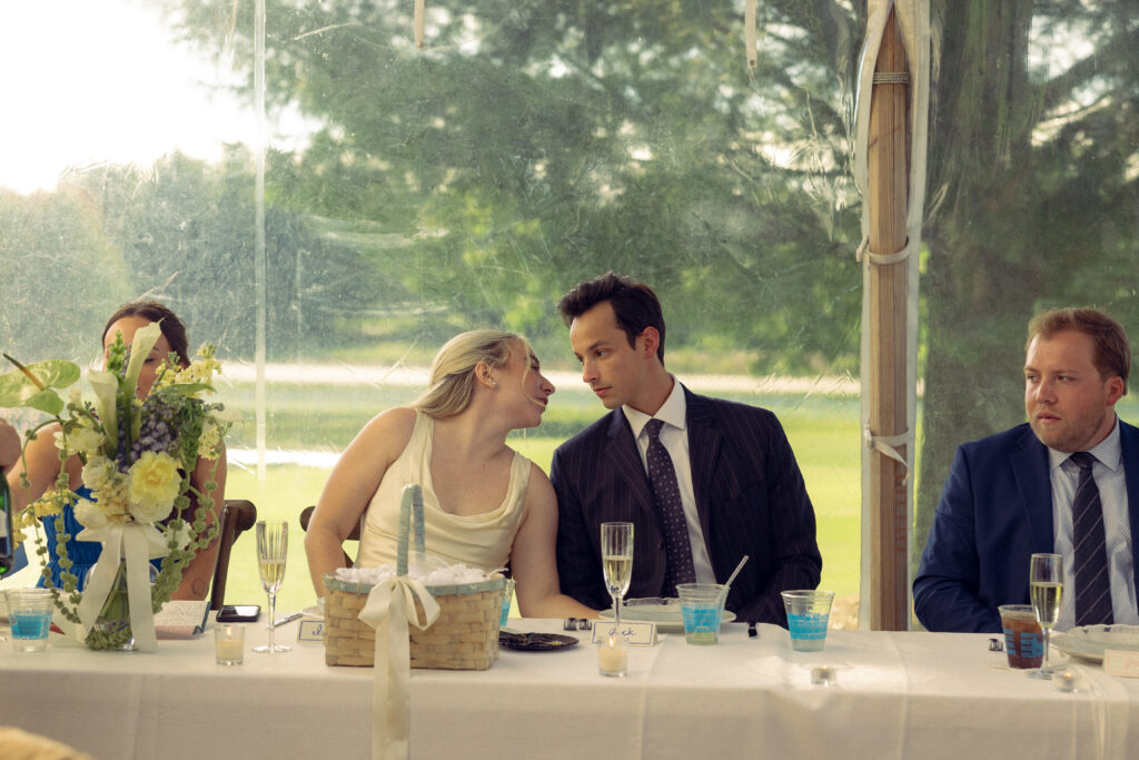 the bride whispers to the groom during their reception in documentary style wedding photography