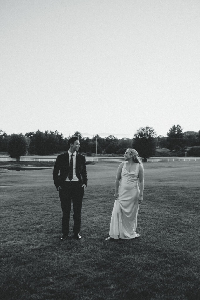 the bride and groom look at each other from a distance away 