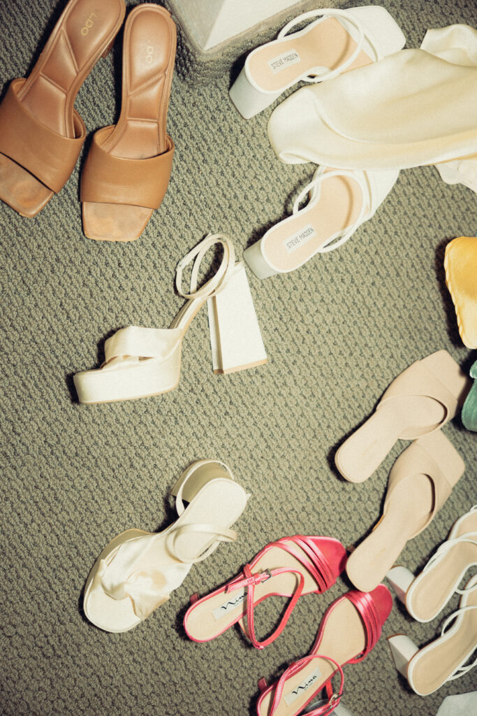 documentary style wedding photos, the bride and bridesmaids shoes sit scattered on the hotel room floor