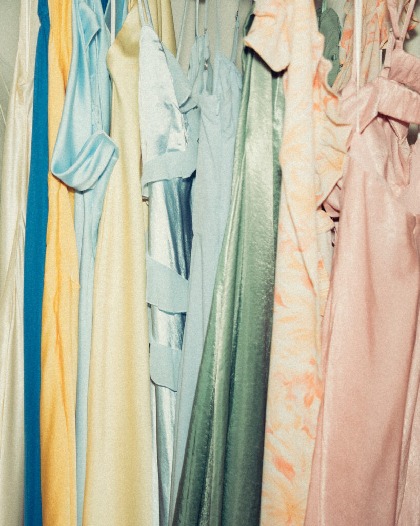 a flash style photo of various colored bridesmaid dresses hanging together