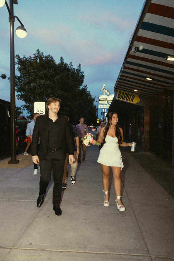 a couple walks on the street during their surprise vegas elopement photography