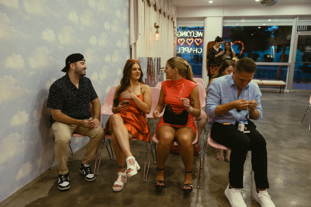 friends of the couple talk before they are surprised with a wedding