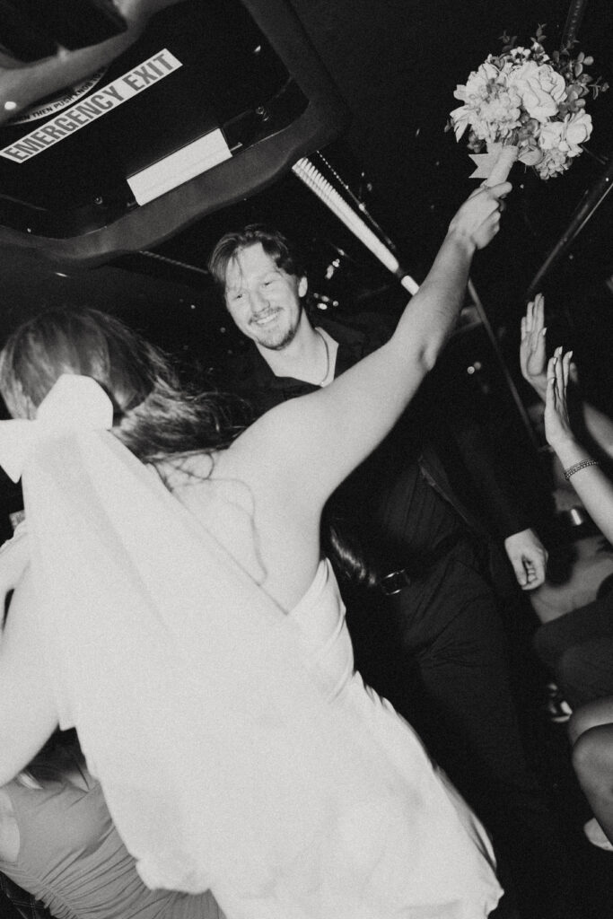 on the partybus during their vegas elopement photography, a new wife turns to give her smiling husband an embrace