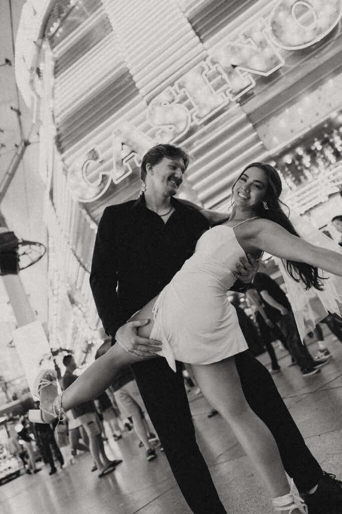 a man dips his wife in front of a las vegas casino for their wedding photos in vegas