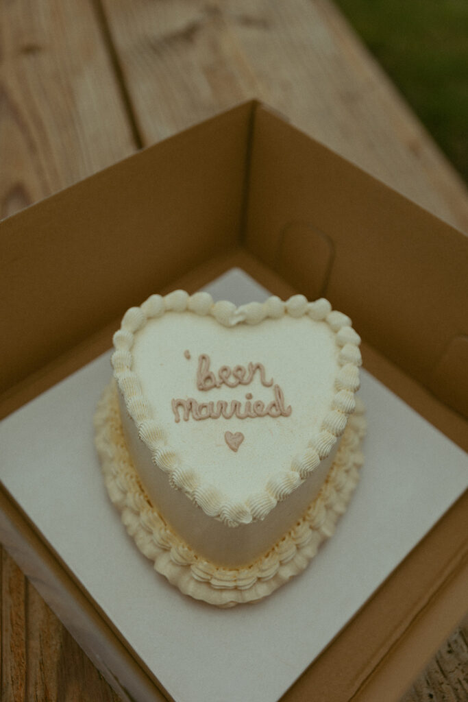 a heart shaped cake with frosting the spells 'been married