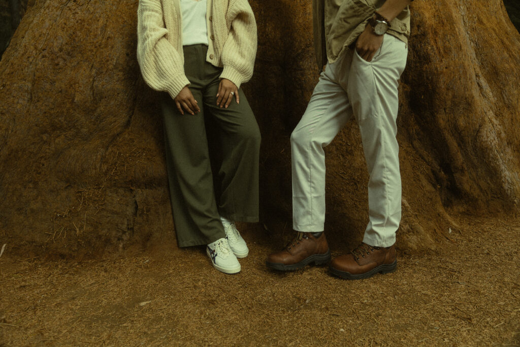 a cropped photo of a couple standing in front of a redwood tree during their sequoia national park engagement photos