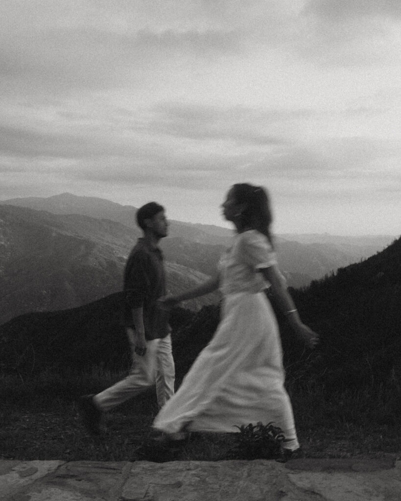 a black and white motion blur portrait of a couple walking in separate directions
