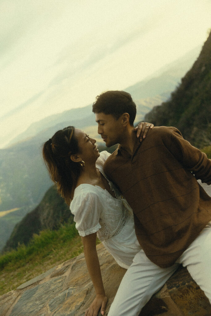 sequoia national park engagement photos where the couple leans into each other while smiling in front a mountain view