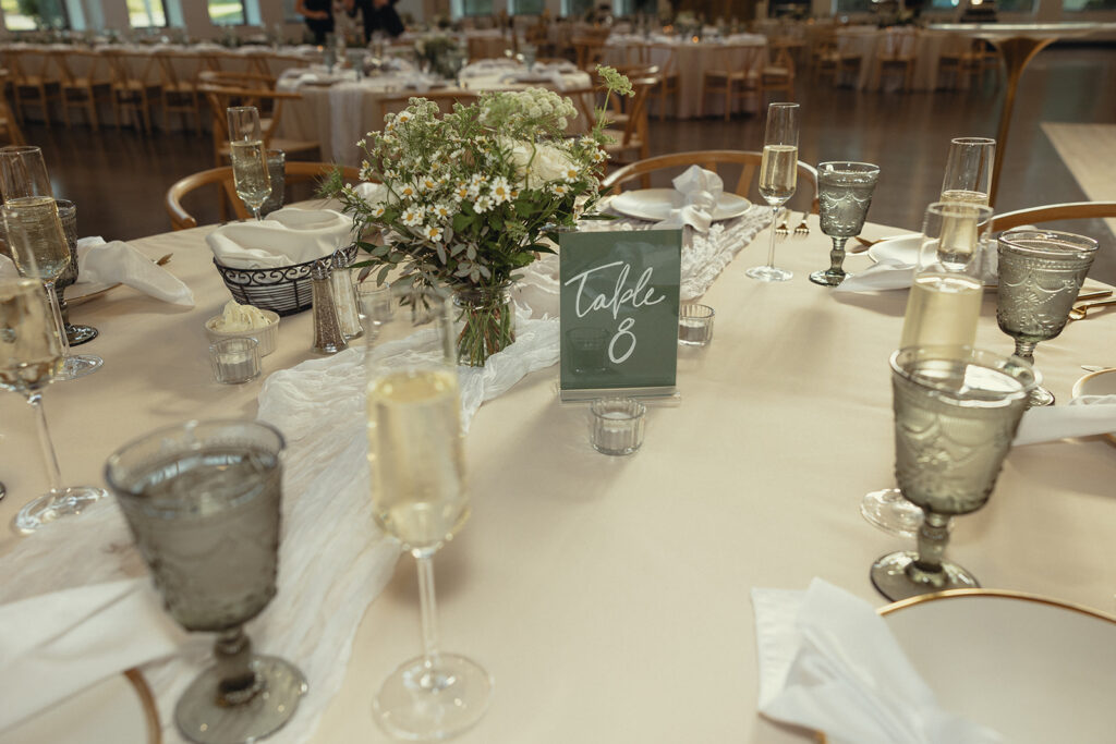 A close up of an elegant white reception table decor taken at a Michigan wedding by grand rapids wedding photographer Anika B photography