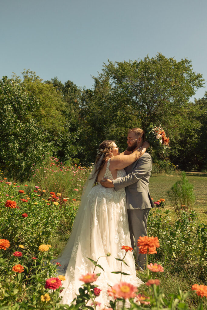 A bride and groom embrace outside the barn wedding venues grand rapids mi