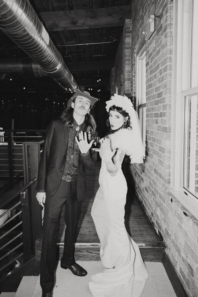 A black and white image of newlyweds showing off their rings at a unique wedding venue in grand rapids mi