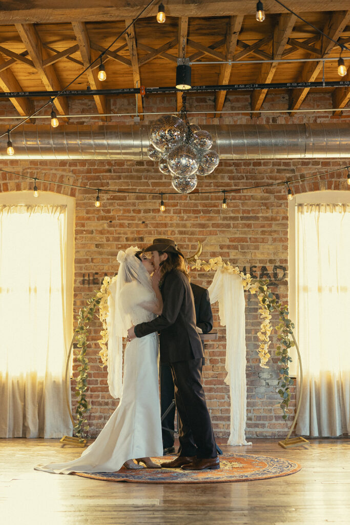 A Michigan bride & groom share a kiss after their vows at their intimate wedding michigan