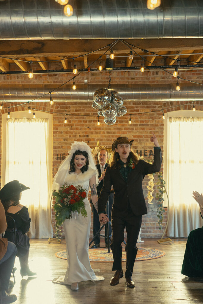 A MI couple celebrates immediately after their wedding vows at The Record Box 