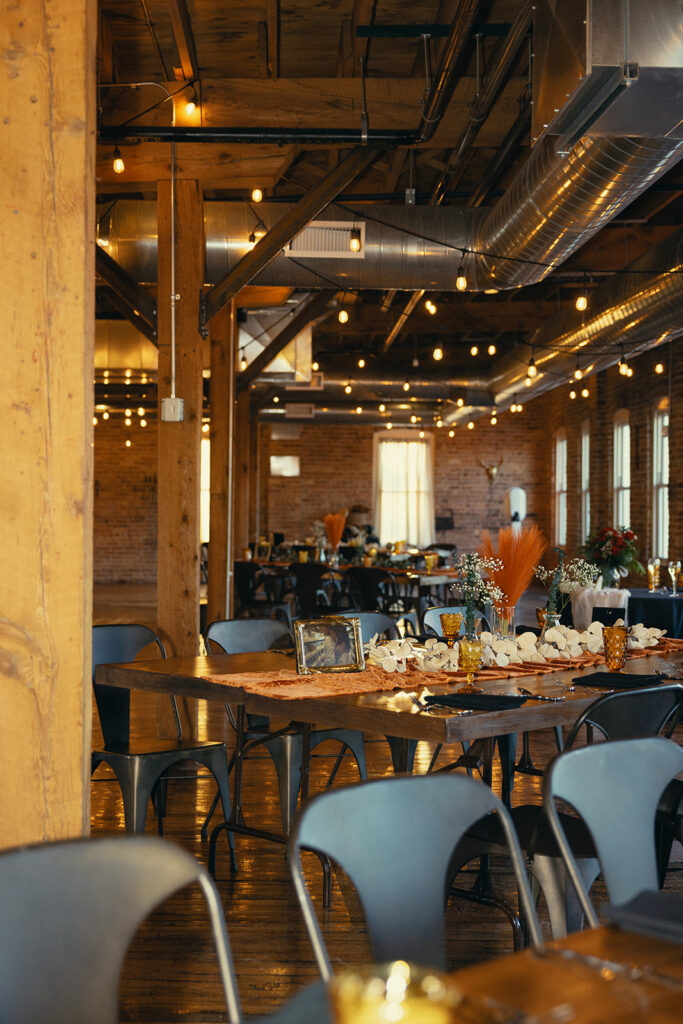 The reception area at The Record Box Loft is pictured with cafe lights strung at a Battle Creek Wedding 