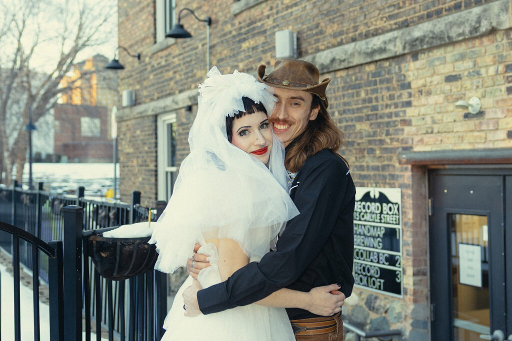 Michigan newlyweds pose for bridal portraits outside their intimate wedding in Michigan at The Record Box