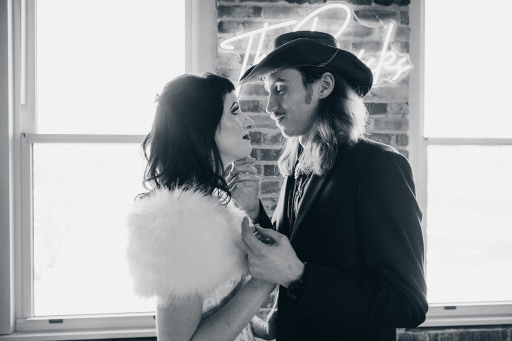 A black and white image of newlyweds in '70s western inspired wedding attire at their Battle Creek Wedding 