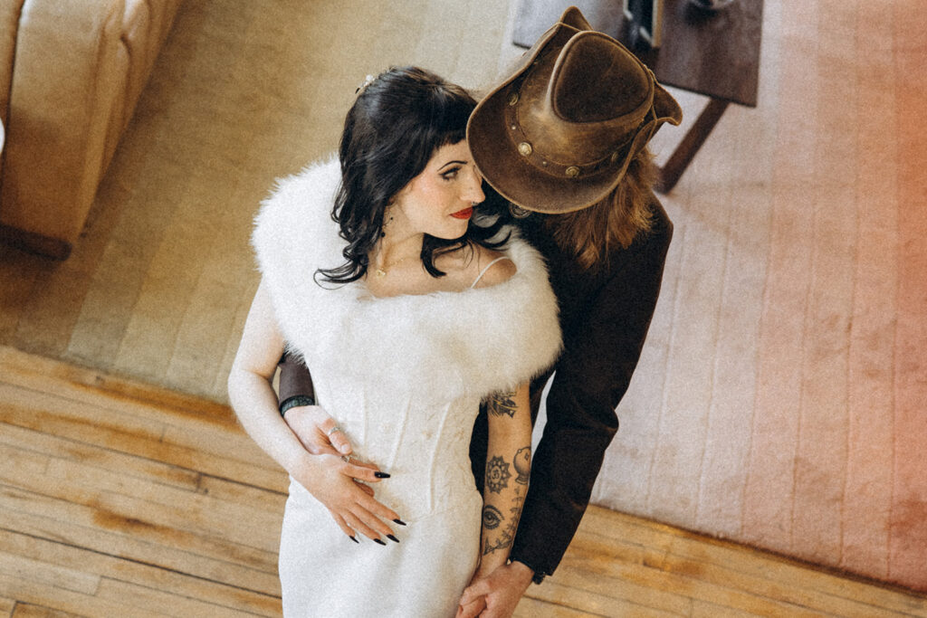 Newlyweds are photographed from a staircase above at their battle creek wedding venue, The Record Box