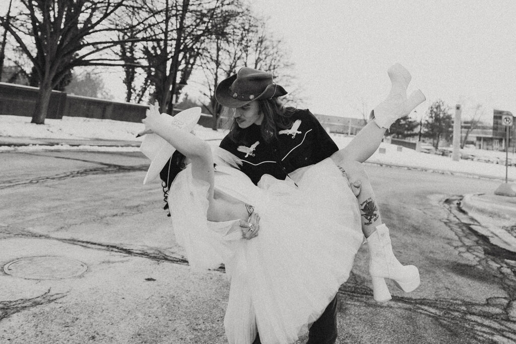 A b+w image of a groom dipping his bride outside Record Box Loft following their Battle Creek wedding 