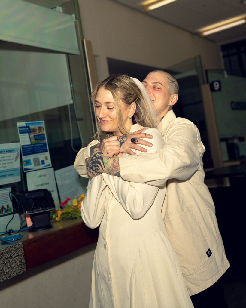 Michigan newlyweds embrace before their Kent County courthouse wedding in a photo taken by Anika B Photography 