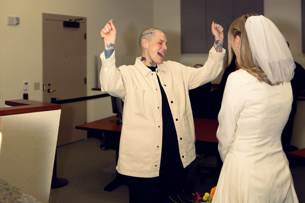 A Michigan couple celebrates getting married in a photo from their Kent courthouse wedding