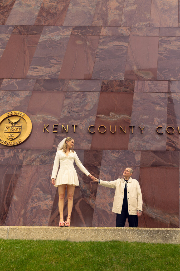 Newlyweds pose for bridal portraits outside their courthouse wedding Grand Rapids MI