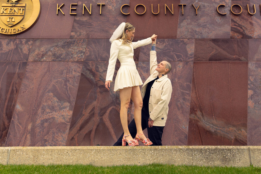 A Michigan couple pose for a photo outside the Kent County Courthouse on their wedding day 