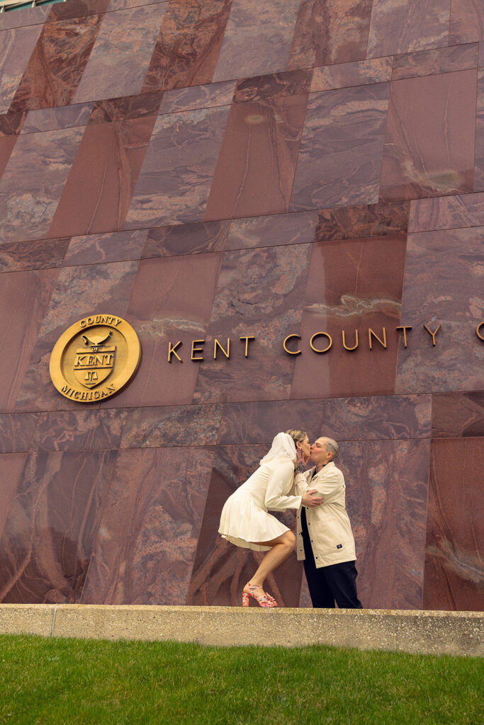 Newlyweds share a kiss outside their  Kent Co. courthouse wedding in Grand Rapids MI