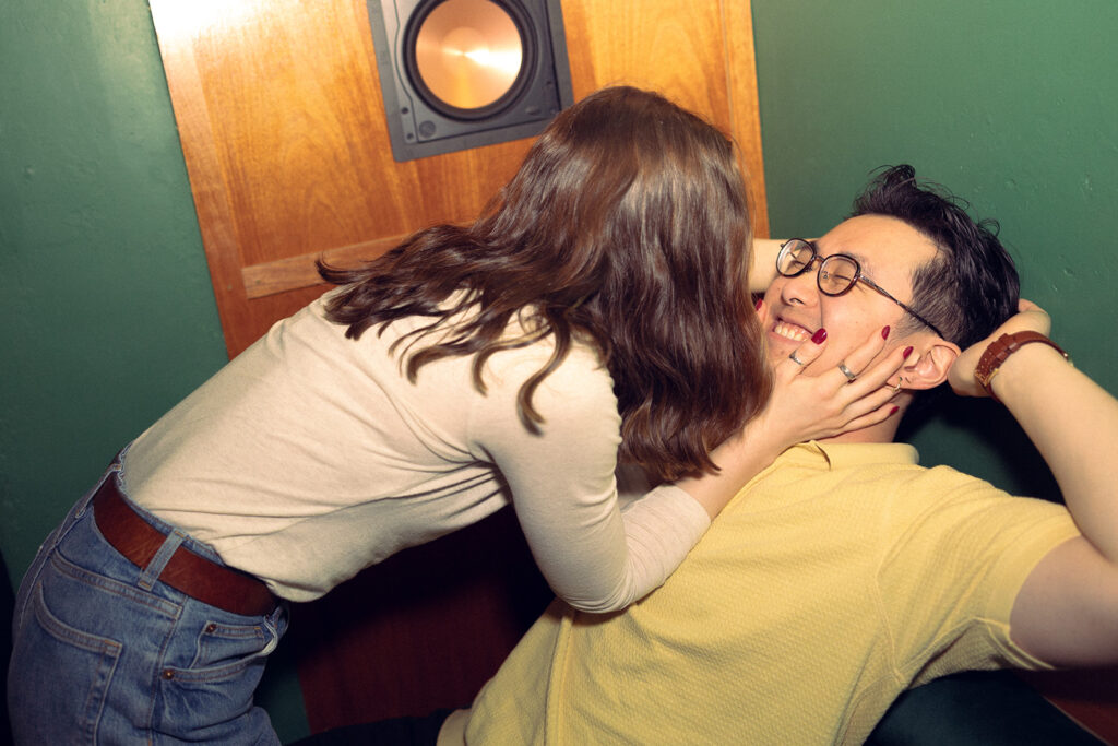 A MI bride-to-be leans in for a kiss from her fiancé during their Detroit engagement photos with Anika B Photography  
