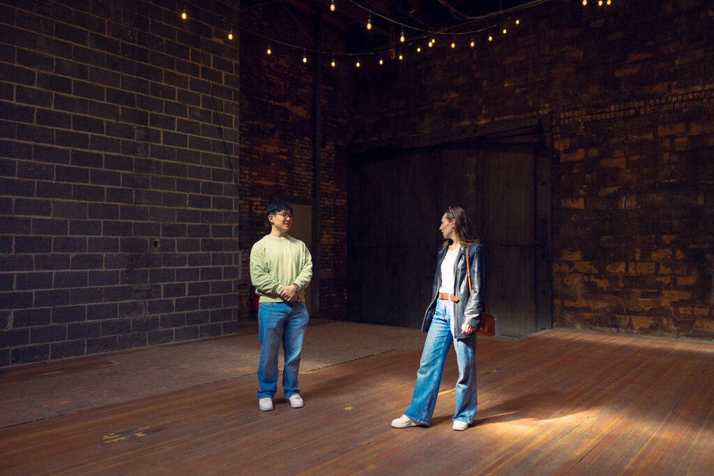 A couple tours The Jam Handy, their future wedding venue, during their Detroit engagement photos 