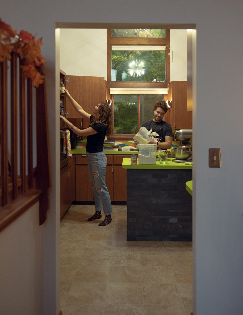 A candid photo taken of a Michigan couple during an in-home sesison with Anika B, one of engagement photographers in  grand rapids mi