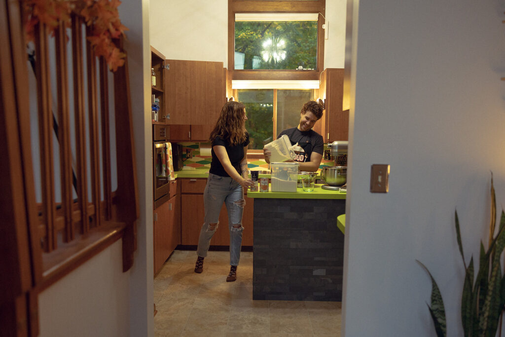 A candid shot of a Michigan couple baking cookies during the in-home segment of their grand rapids engagement photos 