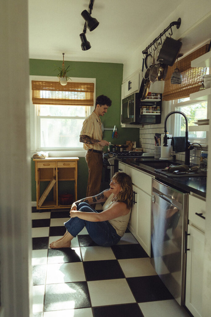 Engagement photos in Michigan depict a newly engaged couple in the kitchen of their home during a shoot with West Michigan Wedding photographer, Anika B Photography