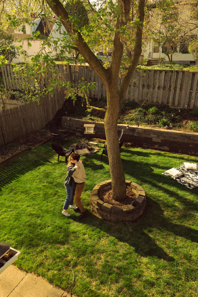 A Grand Rapids couple is photographed in their backyard during Michigan engagement photos with Anika B Photography