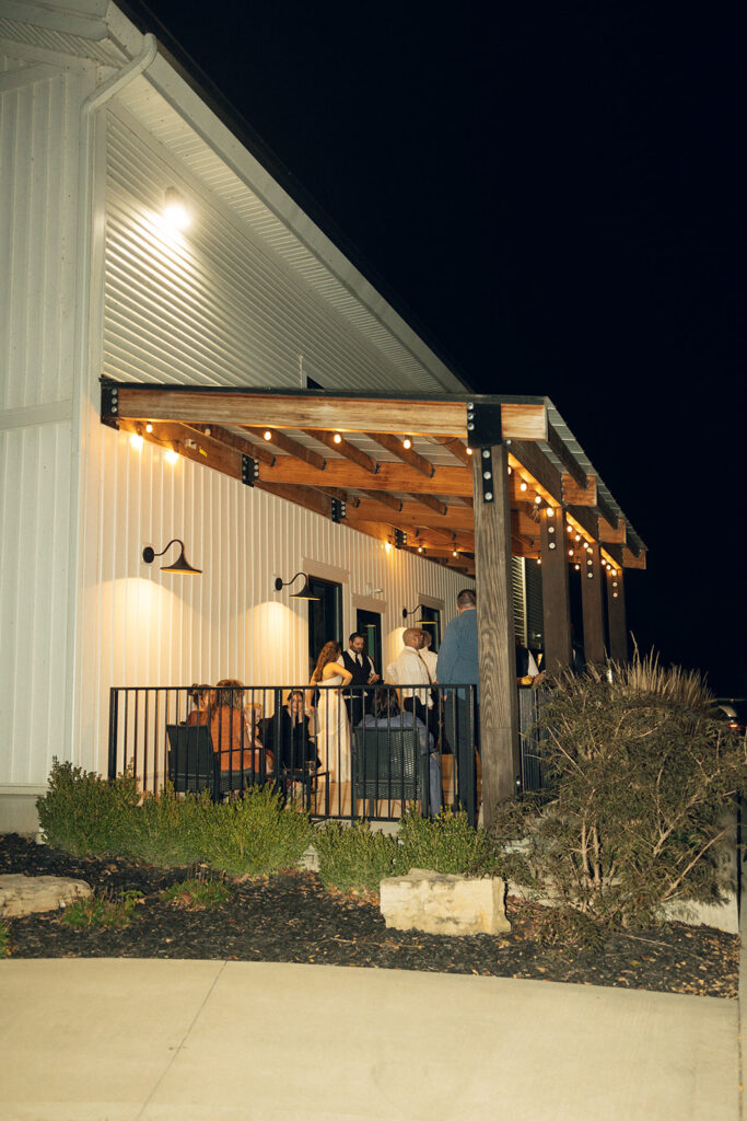 Newlyweds mingle with guests outside at a popular location for wedding receptions in west michigan
