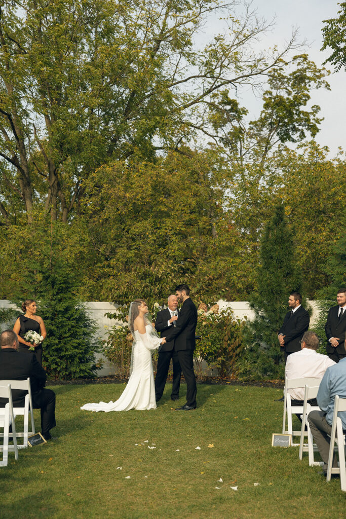 A bride and groom exchange vows at their venue for small weddings in michigan