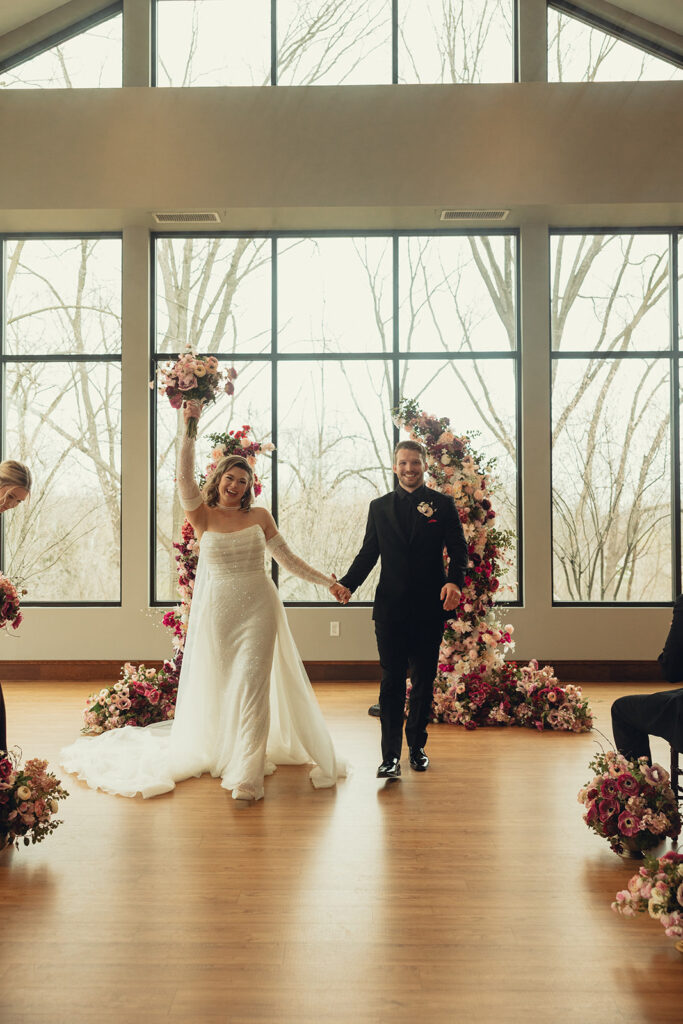 Newlyweds celebrate in their wedding attire taken at the all inclusive Michigan venue where they held their ceremony