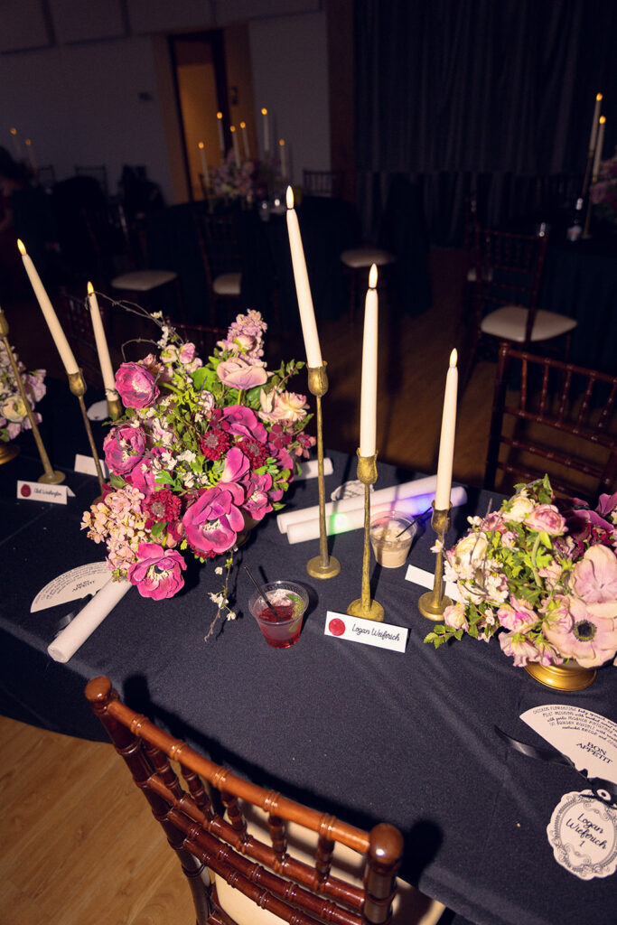 Purple florals and tapered candles are photographed at an elegant Venue3Two wedding
