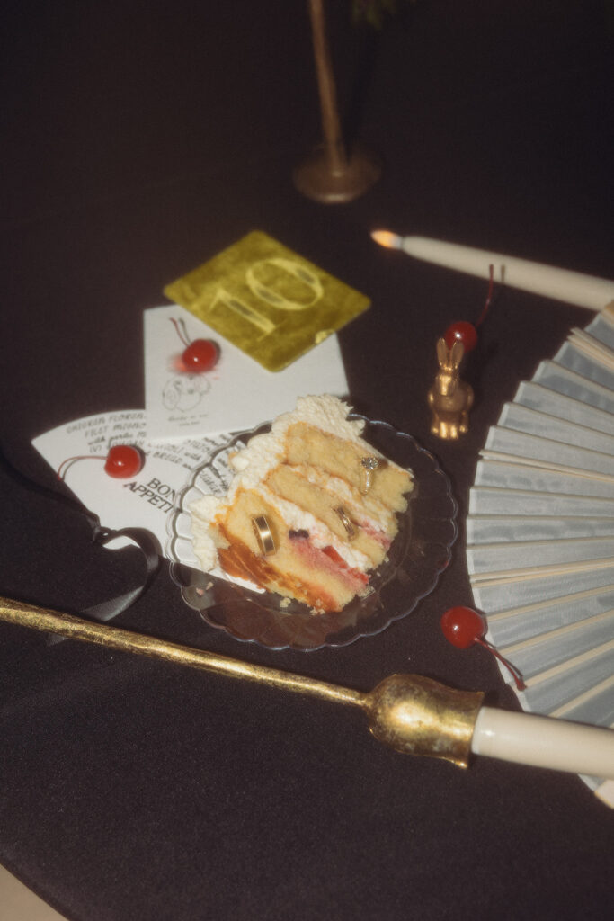 An editoral photo taken by Michigan wedding photographer depicts a slice of wedding cake surrounded by napkins and cherries at a Grand Rapids reception